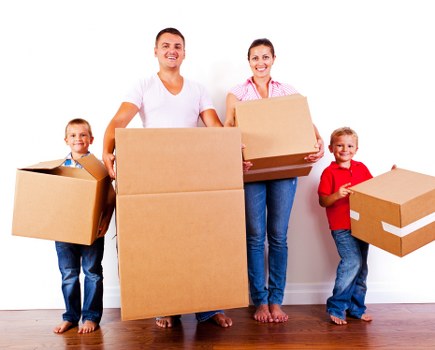 Removal team pricing a move in Soho flat with boxes and furniture